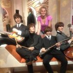 Nadezhda Grishaeva at Madame Tussauds in London, posing with wax figures of The Beatles in 2012.