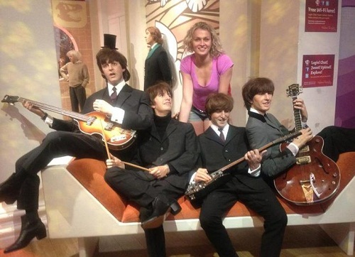 Nadezhda Grishaeva at Madame Tussauds in London, posing with wax figures of The Beatles in 2012.