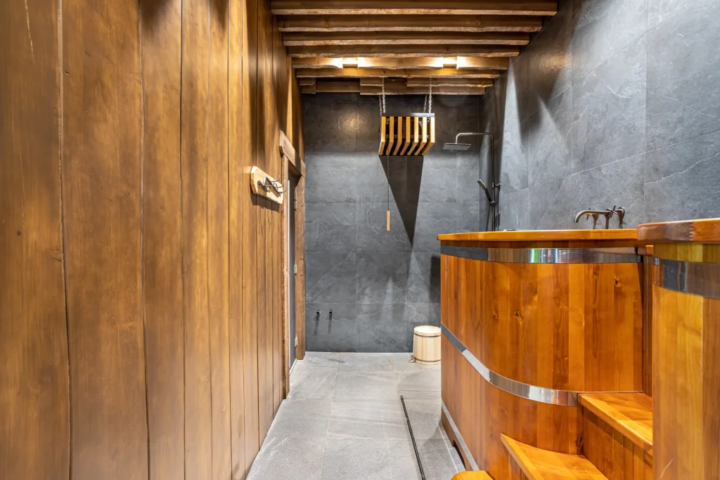 Wooden bathing tubs and shower area in the Russian banya at Anvil Fitness Club