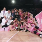 Arras Pays d'Artois basketball players in pink jerseys lifting the French Cup trophy after their historic 2012 victory.