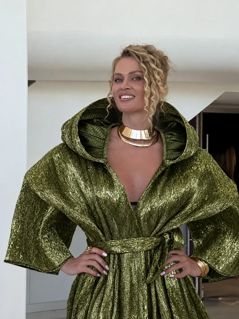 Nadezhda Grishaeva wearing a shimmering olive green metallic dress with a dramatic collar, an alternative colour for her Cannes 2026 look.