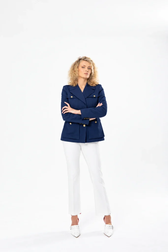 Nadezhda Grishaeva in a navy blue jacket and white trousers in a studio portrait