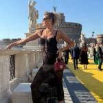 Nadezhda Grishaeva on Ponte Sant'Angelo with Castel Sant'Angelo and marble angel statues in Rome