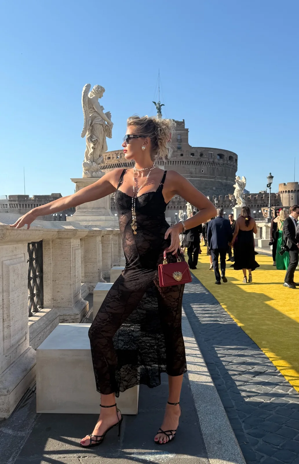 Nadezhda Grishaeva on Ponte Sant'Angelo with Castel Sant'Angelo and marble angel statues in Rome