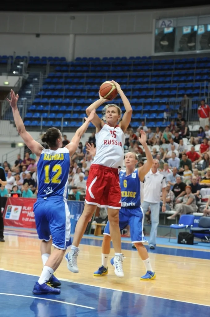 Nadezhda Grishaeva wearing number 15 for Russia, taking a jump shot against Sweden during an international women's basketball game.
